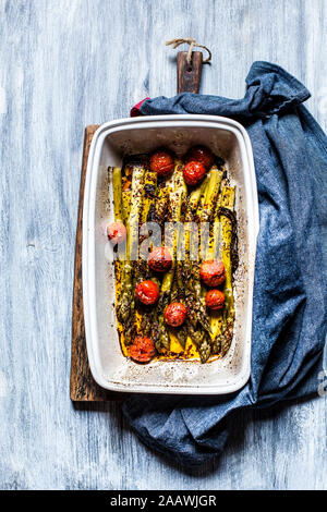 Grilled green asparagus with cherry tomatoes in a casserole Stock Photo