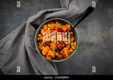 Spicy oriental pumpkin stew with Hokkaido squash, chickpeas, parsley and pomegranate seeds Stock Photo