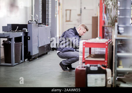 Young man working in a printing company Stock Photo