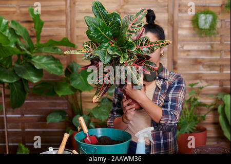 Young woman gardening on her terrace Stock Photo
