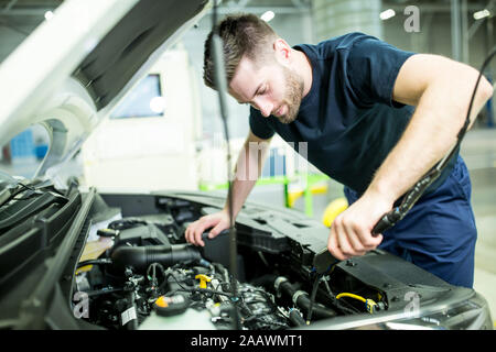 Man working on car in modern factory Stock Photo