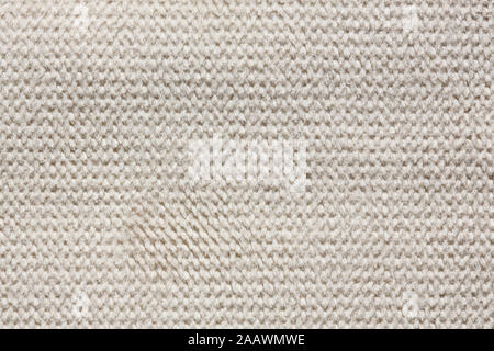 Knitted material background in light tone. Superlative dark leatherette texture. Stock Photo