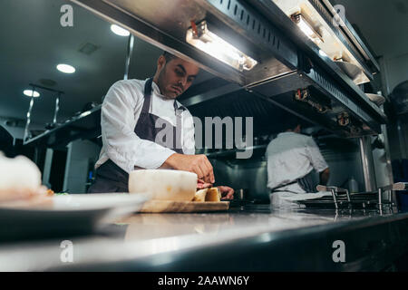 Chef garnishing chopping board with food Stock Photo
