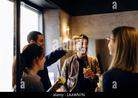 Colleagues celebrating after work in a bar Stock Photo