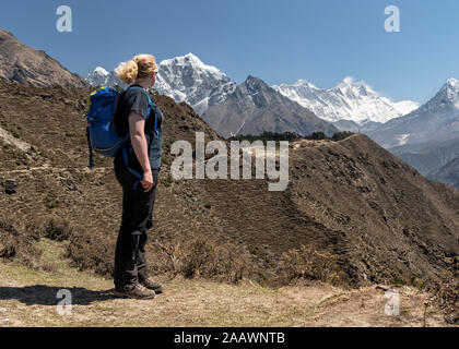Woman looking at Ama Dablam and Mt Everest, Himalayas, Solo Khumbu, Nepal Stock Photo