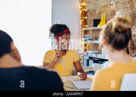 Portrait of young woman in a meeting Stock Photo