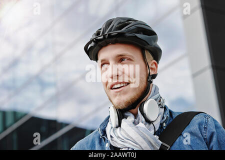 Portrait of student with cycling helmet  and headphones Stock Photo