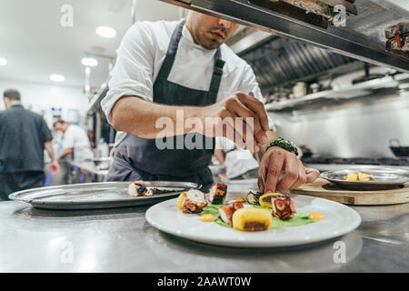 Chef garnishing plate with food Stock Photo