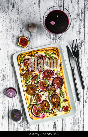 Tart with cheese, garlic, figs, roasted pine nuts, arugula and sauerkraut cabbage Stock Photo