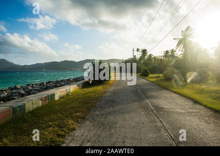 Diminishing perspective of empty road along the beach in Carriacou, Grenada, Caribbean Stock Photo