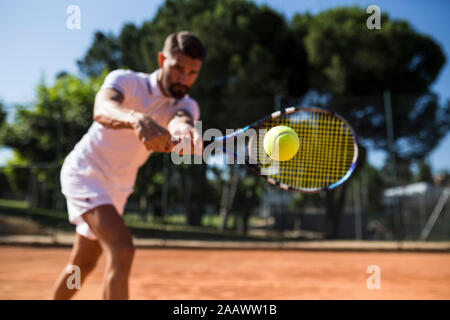 Tennis player during a tennis match, focus on tennis ball Stock Photo