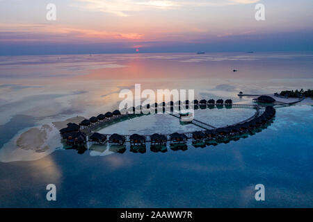 Aerial view of stilt houses at Olhuveli island during sunrise at Maldives Stock Photo