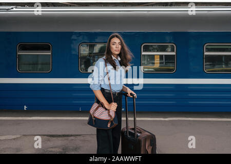 Young female traveller waiting on train station Stock Photo