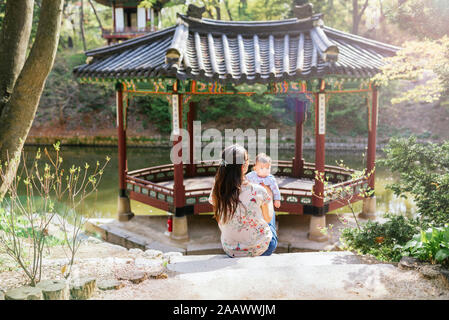 Mother and baby girl visiting pagoda in the Secret Garden, Changdeokgung, Seoul, South Korea Stock Photo