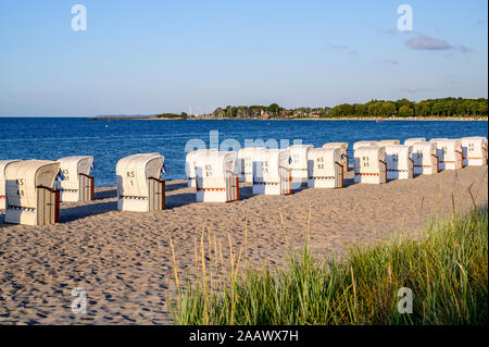 Germany, Schleswig-Holstein, Niendorf, Strandkorb beach-chairs on sandy coastal beach Stock Photo