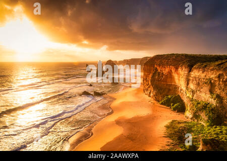 Scenic view of sea against cloudy sky at Twelve Apostles Marine National Park during sunset, Victoria, Australia Stock Photo