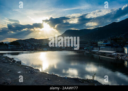 Sun streaming through clouds over Cap Haitien at sunset, Haiti, Caribbean Stock Photo