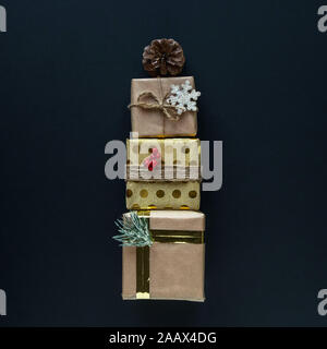 Three beautiful Christmas gift boxes on black background Stock Photo