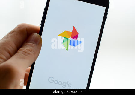 A smartphone with the Google Photos app on it. Stock Photo