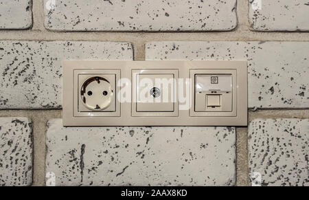 A block of built-in network, television and Internet sockets in a brick wall Stock Photo