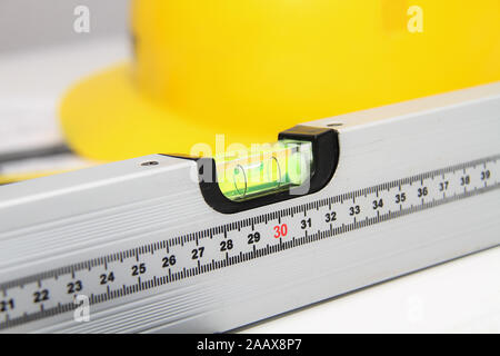 Photo of the Helmet and tools for construction drawings and buildings Stock Photo