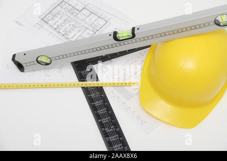 Photo of the Helmet and tools for construction drawings and buildings Stock Photo