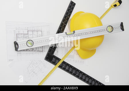 Photo of the Helmet and tools for construction drawings and buildings Stock Photo