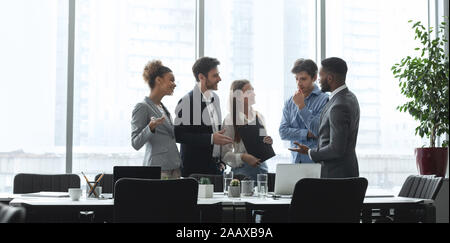 Diverse management team talking in conference room Stock Photo