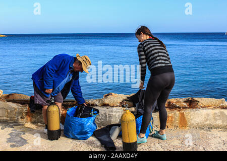 Preparing the dive kit at St Elmo's Bay, Malta. Stock Photo