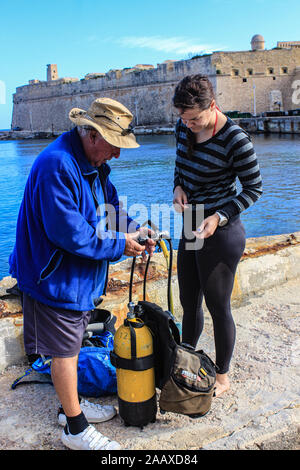 Preparing the dive kit at St Elmo's Bay, Malta. Stock Photo
