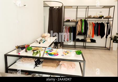 Tailor's Atelier Background With Workplace, Clothes Hangers And Sewing Tools Stock Photo