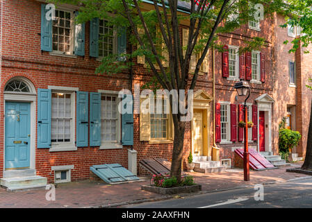 Afternoon sunshine lights up colourful wooden shutters on historic row houses in South 4th Street, Society Hill. Stock Photo