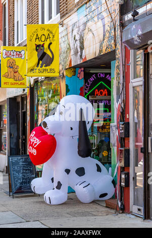 A giant inflatable dalmation puppy on the sidewalk outside the