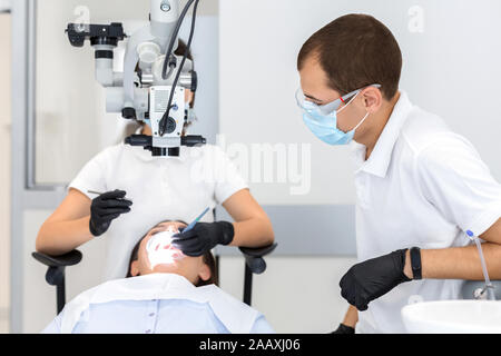 High class service in dental cabinet, two dentists making surgery Stock Photo