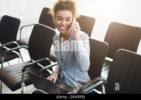 Young woman working in empty conference room Stock Photo