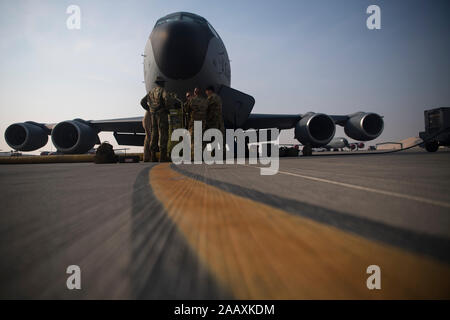 385th Expeditionary Aircraft Maintenance Squadron Airmen and a 28th Expeditionary Air Refueling Squadron aircrew perform pre-flight inspections on a KC-135 Stratotanker before an aerial refueling mission at Al Udeid Air Base, Qatar, Oct. 25, 2019. During the mission, the KC-135 aircrew provided aerial refueling for a B-1B Lancer in the U.S. Central Command area of operations. The B-1 flew directly from its home station of Ellsworth Air Force Base, S.D., demonstrating the U.S. Air Force’s ability to rapidly deploy strategic bombers anywhere in the world.  (U.S. Air Force photo by Master Sgt. Ru Stock Photo