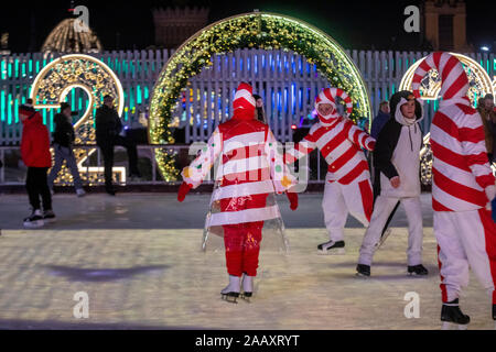 Moscow, Russia. 22nd of November, 2019 People in fancy costume at an ice skating rink, believed to be the biggest in Europe, in Moscow's VDNKh Exhibition Centre; the ice covers an area of 20,500 square metres Stock Photo