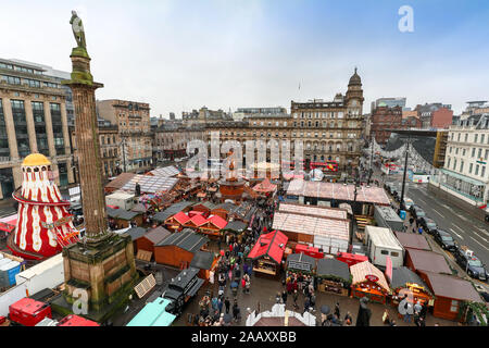 Glasgow, UK. 24 November 2019, As part of Glasgow's festive celebrations, the annual Christmas market officially opened in the city's George Square with a funfair, gift shops and chalets selling an selection of international foods. George Square is traditionally the centre of the city's celebrations and all corners of it are prepared for the thousands of tourists who will visit the city and the markets. Credit: Findlay/Alamy Live News Stock Photo