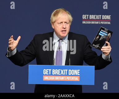 Prime Minister Boris Johnson holds up his party's manifesto during its launch at Telford International Centre in Telford, West Midlands. Stock Photo