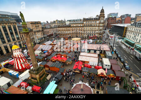 Glasgow, UK. 24 November 2019, As part of Glasgow's festive celebrations, the annual Christmas market officially opened in the city's George Square with a funfair, gift shops and chalets selling an selection of international foods. George Square is traditionally the centre of the city's celebrations and all corners of it are prepared for the thousands of tourists who will visit the city and the markets. Credit: Findlay/Alamy Live News Stock Photo