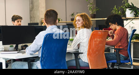 Working process of young people at workplace Stock Photo