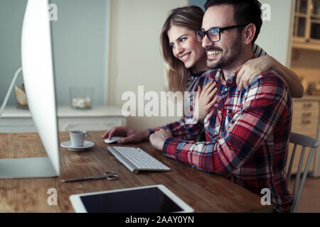 Young couple of designers working on computer Stock Photo