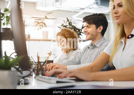 Casual business people working on computers in office Stock Photo