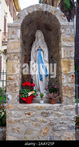 close view of Madonna statue and entrance door of Saint Peter's Church in small village in France Stock Photo