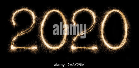 2020 written with sparkling holiday font on black background Stock Photo
