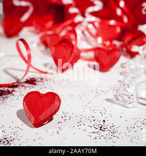Love and Valentines: love hearts. Valentine's Day themed still life with love hearts and streamers. Stock Photo