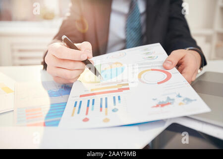 Fisheye view of unrecognizable businessman showing colorful data graph to camera, copy space Stock Photo