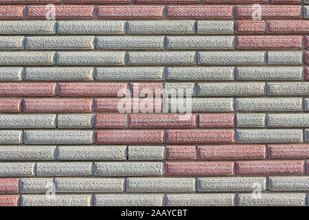 Wall pattern of red and grey gray concrete brick blocks Stock Photo