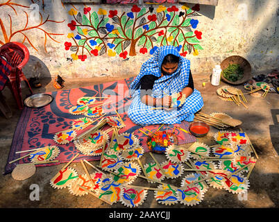 Pingla, West Bengal, India. 23rd Nov, 2019. Village woman making crafts.Naya Village under Pingla Block is a small village under Paschim Midnapore District of West Bengal, India which is famous for their colourful Ancient Folk Art. Almost 60 Families of this village are associated with the Art Patachitra, an ancient folk art of Bengal, the art is appreciated by art lovers all over the world for its style of drawings, shape, pattern, textures and colours. The Art is based on mythological tales and tribal rituals to stories based on modern Indian history and contemporary issues happening in Stock Photo