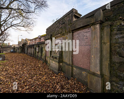 Old churchyard wall with tombs and graves, due to be rebuilt as part of Trams to Newhaven work, South Leith Parish Church, Edinburgh, Scotland, UK Stock Photo